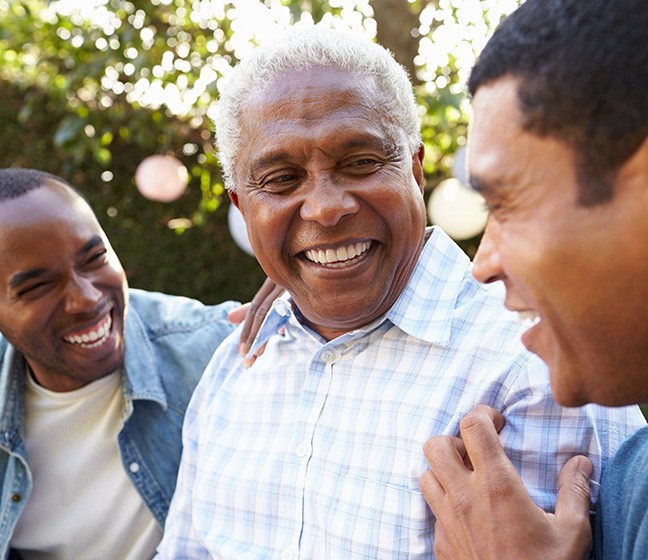 Dentures patient in Dallas smiling with family