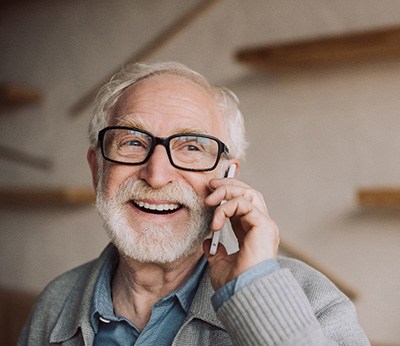 Dentures patient in Dallas talking on the phone