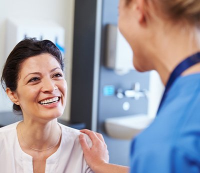 Dentures patient in Dallas smiling at dentist