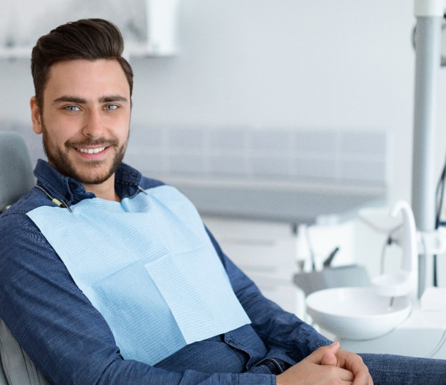 Bearded male patient waiting for cosmetic dental bonding in Dallas, TX