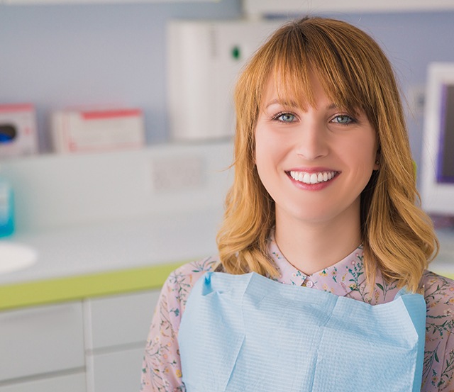 Red-haired female patient in dental chair