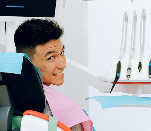 Man in dental chair looking over his shoulder